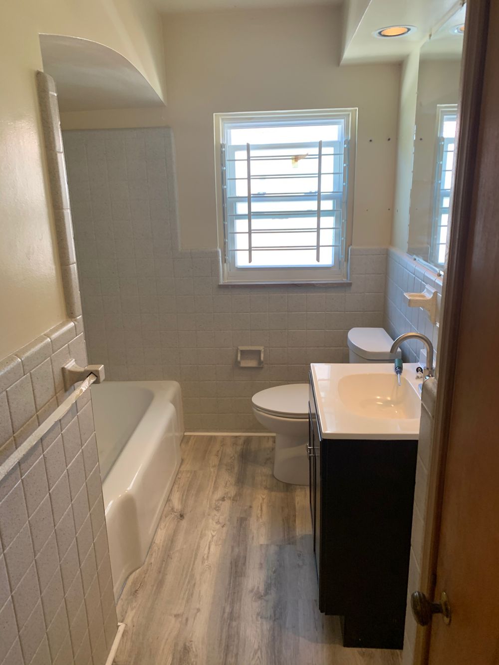 Refreshed bathroom after tile and fixture refinishing