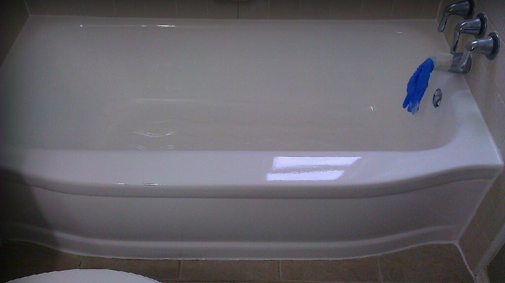 The same bathtub after refinishing, restored to a glossy factory-fresh white finish