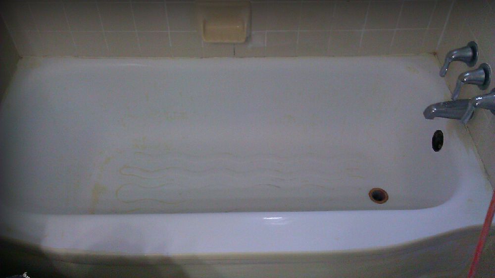 Bathtub mid-refinishing with drain prep visible